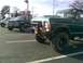1979 Ford Bronco - Green Ford Bronco with off-road tires and a brush guard is parked in a lot.