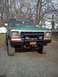 1979 Ford Bronco - This 1979 Ford Bronco is parked outside on a gravel driveway with trees in the background.