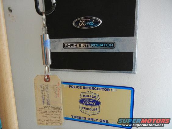 Ford Police Interceptor badge and license plate with a keychain attached