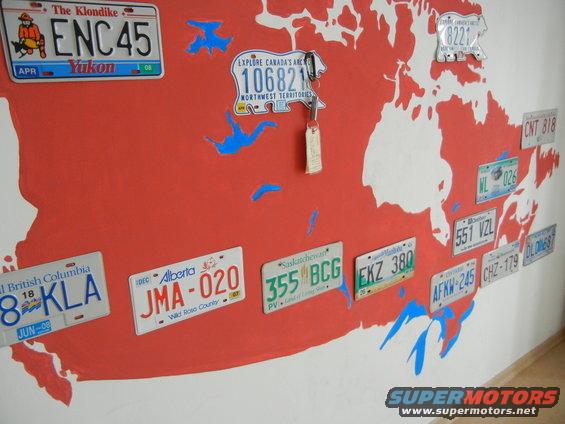 Canadian map mural with license plates from various provinces and territories. Keys hang from one plate
