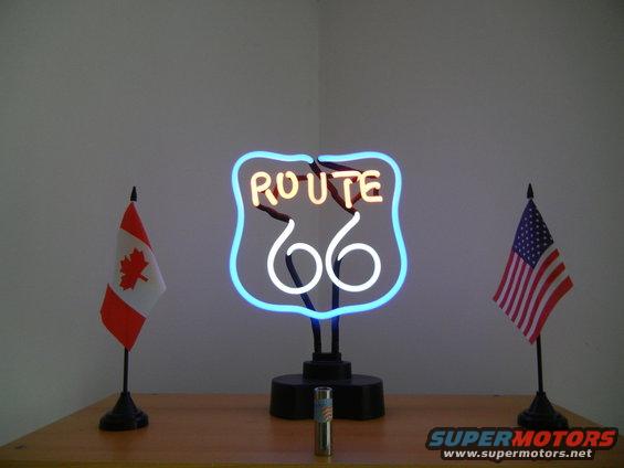Neon Route 66 sign with Canadian and US flags on a table