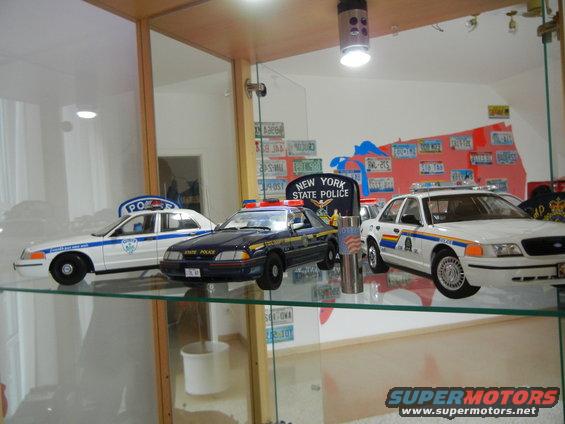 Model police cars on display shelf, one is a 1999 Lincoln Town Car