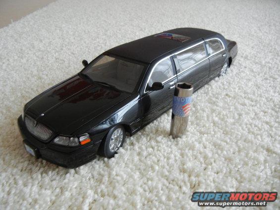 Black limousine model on white carpet, with a vote-themed socket tool