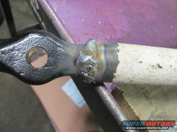 Close-up of a welded metal part with a hole