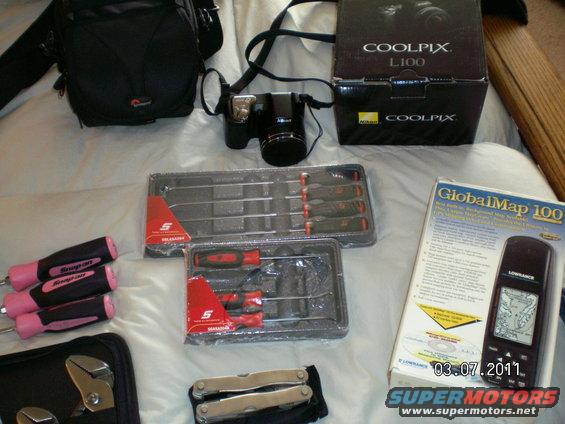 002.jpg Nikon digital 35mm  camera w/case, Snap on long/short pick sets, GlobalMap handheld mobile GPS device, multifunction tool.