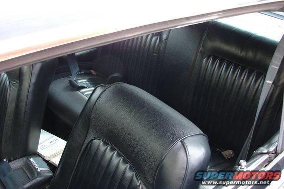 Black vinyl pleated rear seat and front seat of a 1968 Mercury Cougar