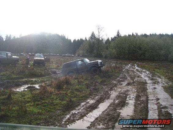 1978 Ford Bronco stuck in mud, other off-road vehicles in background
