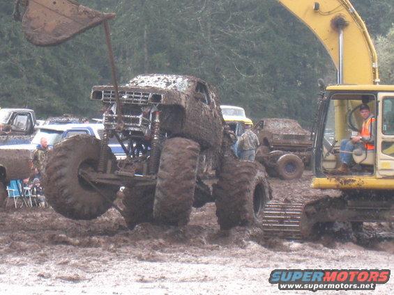 Mud-covered 1978 Ford Bronco monster truck with large tires, front view