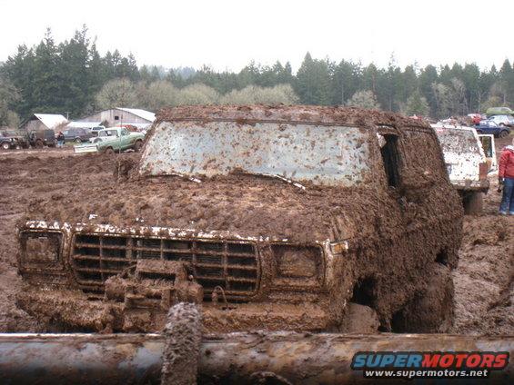 Mud-covered 1978 Ford Bronco front view stuck in mud
