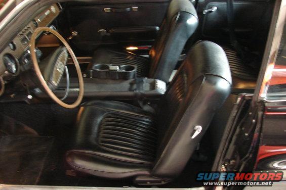 car interior with black seats, steering wheel, and center console