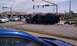 1989 Ford Bronco - An overturned dark SUV lies on its side following a traffic accident, with emergency services on the scene.