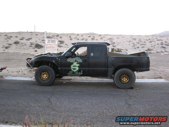 Black pickup truck with off-road tires and custom graphics on the side