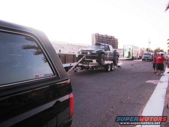 Off-road pickup truck on a trailer, viewed from the side