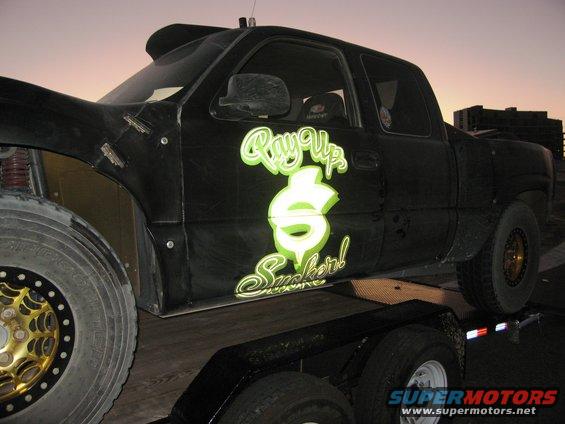 Black pickup truck with 'Ray Up Sucker!' graphics on trailer