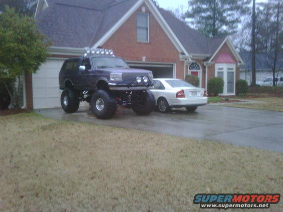 Purple lifted 1995 Ford Bronco with off-road lights