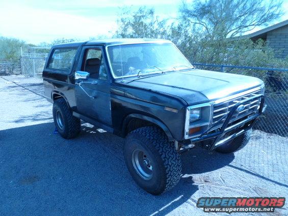 Black SUV with aftermarket front bumper and lifted suspension