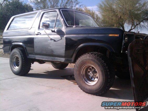 Black SUV with mismatched doors, 3/4 front view