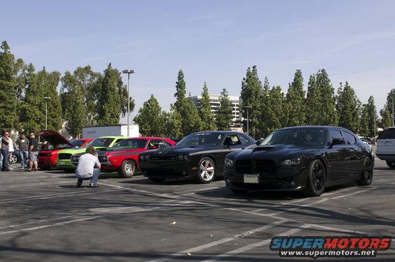 Black Dodge Charger parked in a lot with other cars