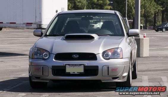 Silver Subaru Impreza WRX STI with hood scoop and STI badges, front view