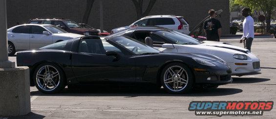 Black Chevrolet Corvette C6 convertible parked next to a white Chevrolet Camaro
