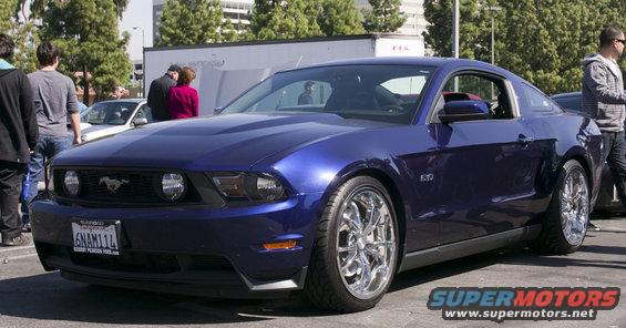 Blue coupe with chrome wheels and a 5.0 badge