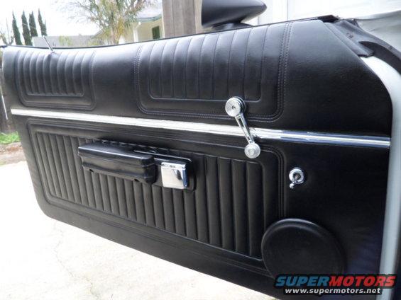 black vinyl door panel with chrome window crank and door handle