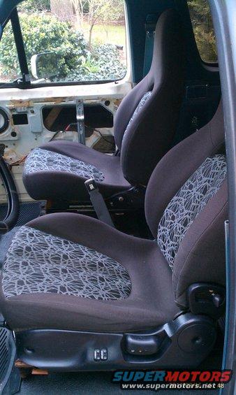 Interior view of aftermarket bucket seats with patterned inserts