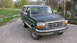1992 Ford Bronco - This 1992 Ford Bronco is seen from a 3q-front angle, its dark green paint and white removable top.