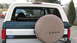 1992 Ford Bronco - The rear of a 1992 Ford Bronco is shown with a spare tire cover and Ford badging.