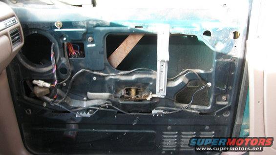 Interior door panel removed, showing window mechanism and wiring. 1992 Ford Bronco