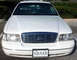 1999 Mercury Grand Marquis - A white sedan is parked outdoors, showing its front grille and headlights.