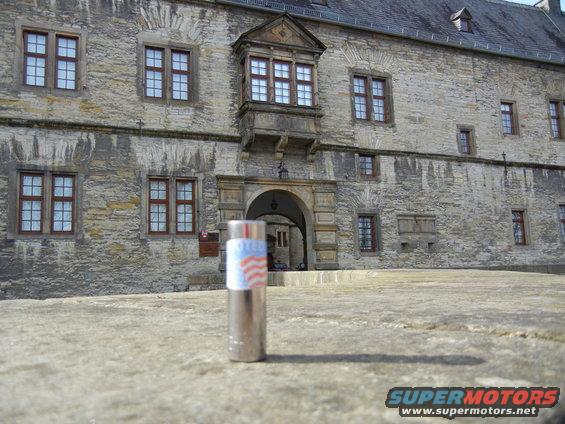 Lighter with American flag design in front of a stone building