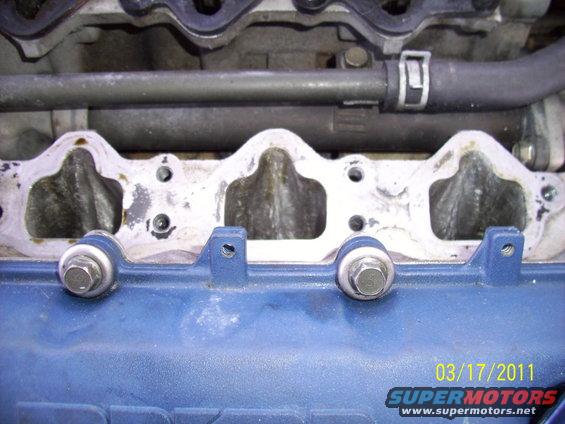 Blue engine intake manifold with bolts and gasket