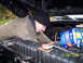 1978 Ford Bronco - A mechanic works on the engine of a vehicle, with new NAPA spark plug wires and other parts nearby.