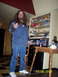1978 Ford Bronco - Man standing indoors with shelves of items and a table with bottles visible in the background. Date stamp shows 11/08/2009.