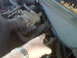 1993 Lincoln Town Car - A hand points to a hose in the engine compartment of a vehicle.