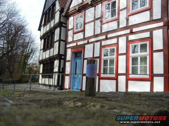 Socket wrench extension with 'I VOTE' sticker in front of a half-timbered building