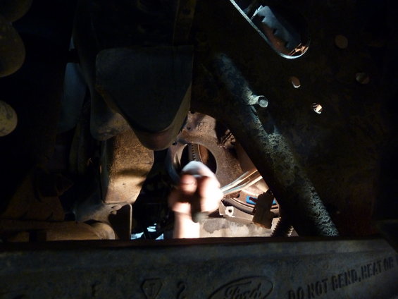 Transmission bell housing with torque converter visible. Ford logo and text 'DO NOT BEND, HEAT OR' visible on lower part