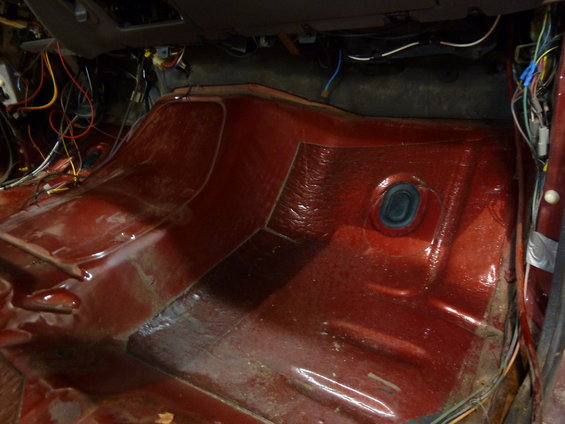 Interior floor and exposed wiring of a vehicle