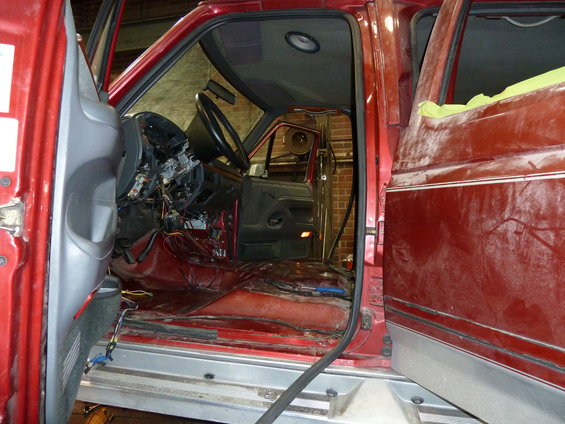 Interior of red truck with dashboard removed and wires exposed
