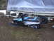 1987 Polaris Indy 600 - 1987 Polaris Indy 600 snowmobile sits beside a boat covered by a tarp.