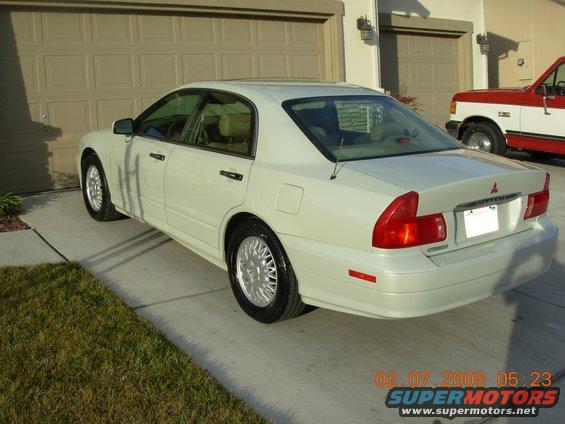 White sedan parked in driveway, timestamp 02.07.2008