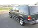 1997 Ford Explorer - A dark green Ford Explorer is shown from the rear quarter angle on a paved surface.