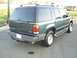 1997 Ford Explorer - The rear of a green Ford Explorer SUV is shown, a roof rack and side steps.