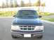 1997 Ford Explorer - The front grille and headlights of a 1997 Ford Explorer are visible, along with a California license plate.