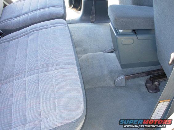 1997 Ford Explorer interior with blue patterned seats, center console, and floor mats