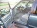 1997 Ford Explorer - The interior of a 1997 Ford Explorer, a gray cloth seat and dashboard with visible gauges.