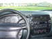 1997 Ford Explorer - The interior of a 1997 Ford Explorer, the dashboard with radio and climate controls.