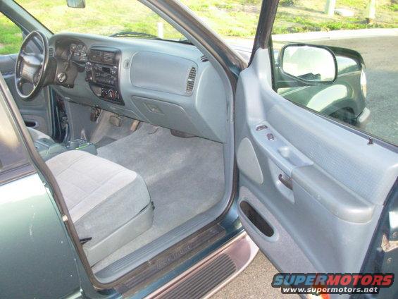 Interior of a 1997 Ford Explorer, showing dashboard, seats, and door panel