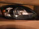2003 Ford Taurus - Headlight assembly for a car, shown in its packaging.